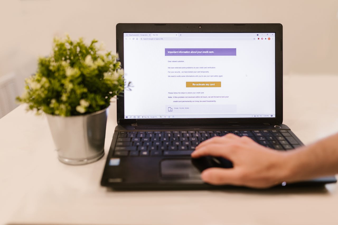 A suspicious phishing email open on a laptop