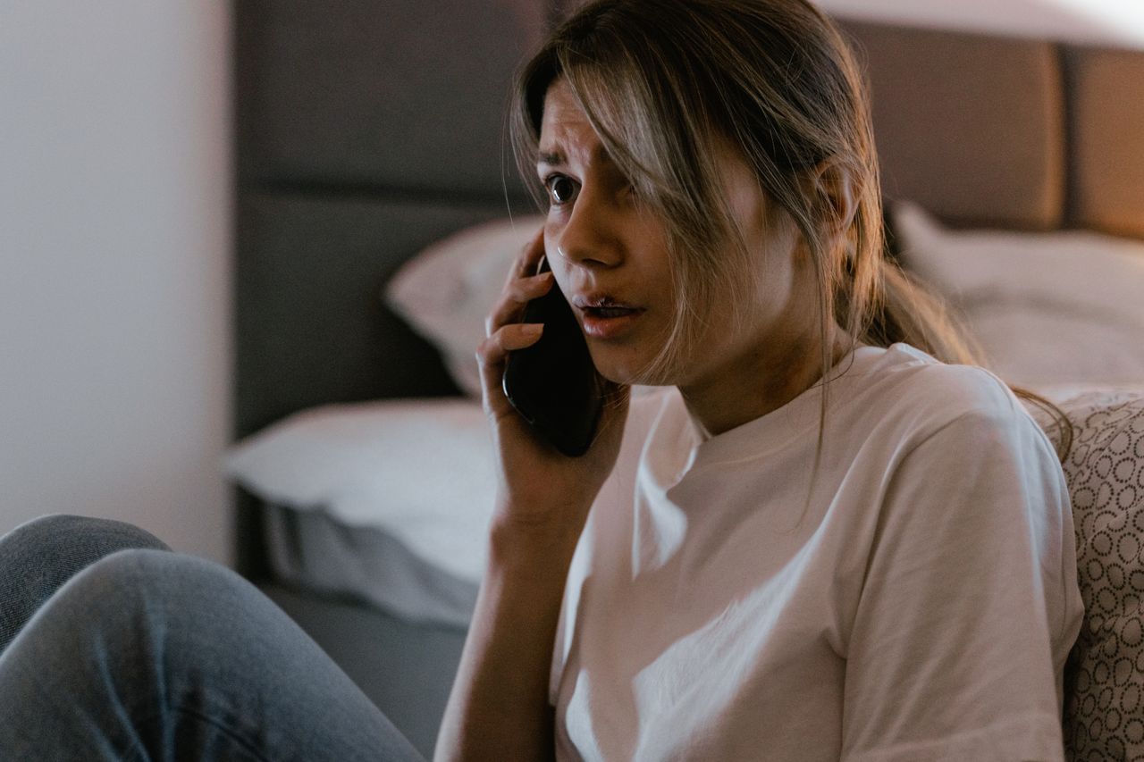 A person looking worried during a call from an unknown number